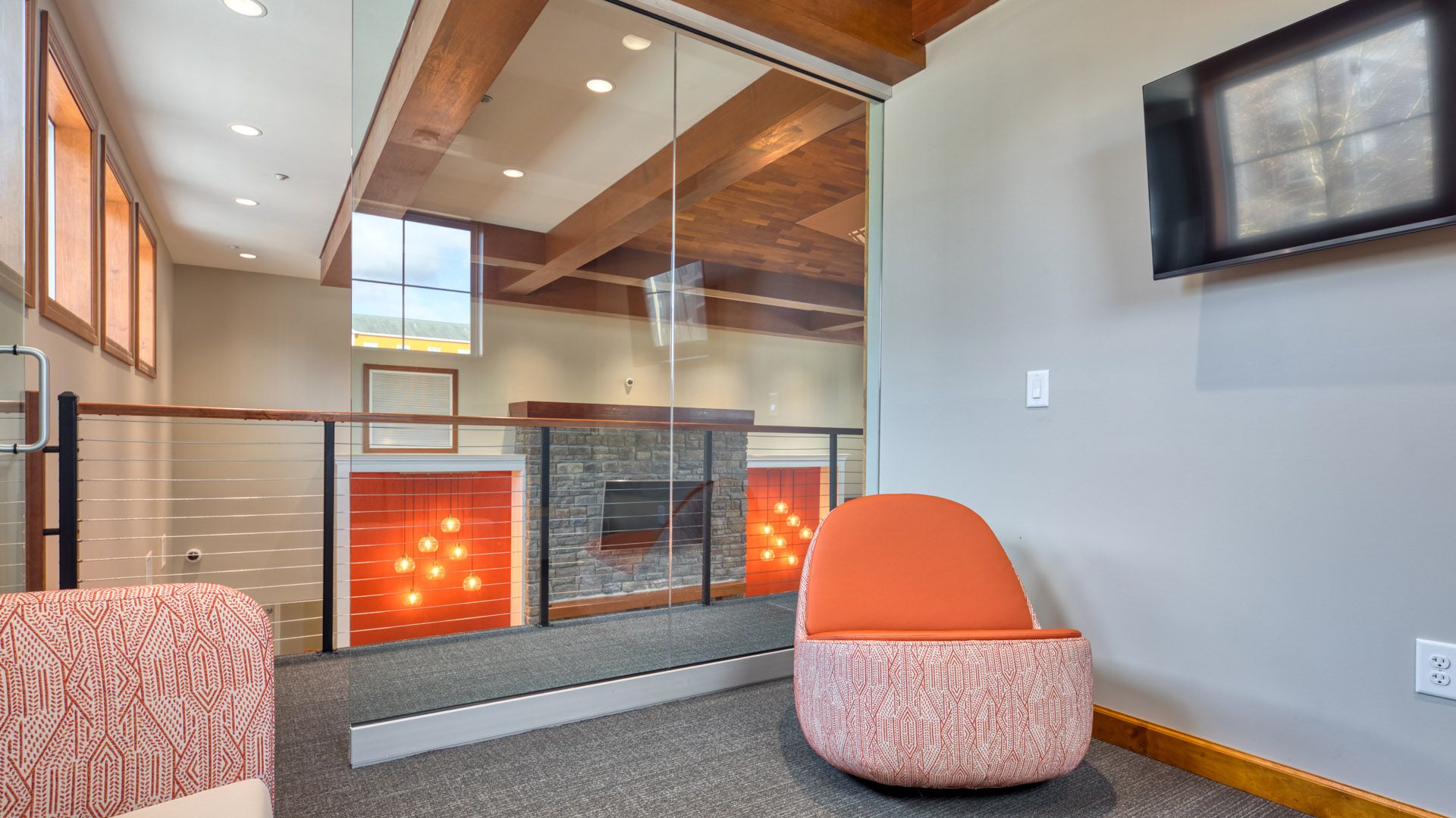 A modern living room with a fireplace and a chair.